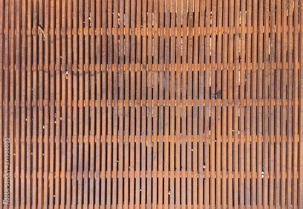 Close up full frame view of a section of a rusty metal grate covering a hole on a street during construction Close up full frame view of a section of a rusty metal grate covering a hole on a street during construction