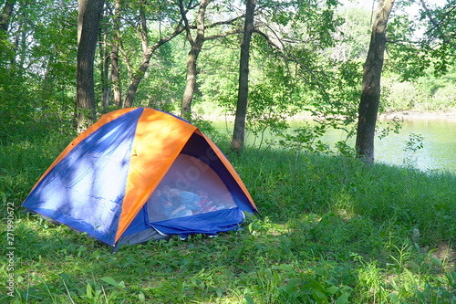 Tourist tent on the background of forest and river