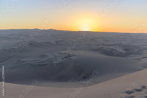 sunset at huacachina desert oasis in peru