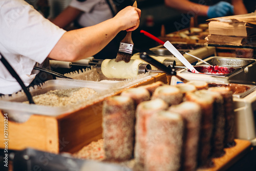 The most popular dessert in Prague. Grilled food. Manufacturer trdelnikov in Prague. Selective focus