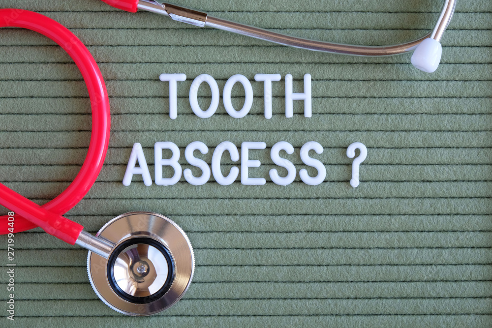 Tooth abscess text with a question mark on green background with