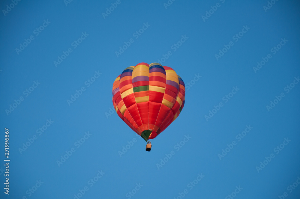 Big balloon. Balloon. Colorful bowl with basket. In the sky soars in the summer Big balloon. Balloon. Colorful bowl with basket. In the sky soars in the summer