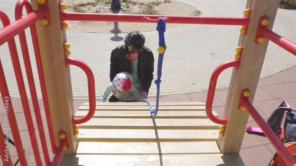 Little beautiful caucasian girl 3 years old plays with her mother in a modern playground for children, childrens house Little beautiful caucasian girl 3 years old plays with her mother in a modern playground for children, childrens house