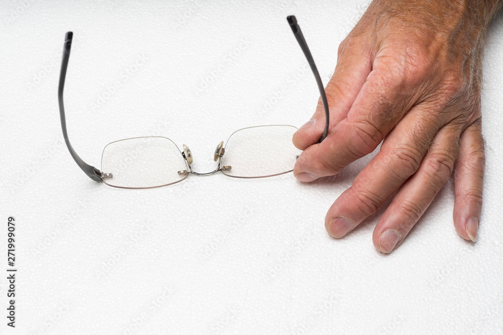 Eye glasses frameless in the hand on white background. Eye glasses no frame held in the hand on white background Eye glasses frameless in the hand on white background. Eye glasses no frame held in the hand on white background