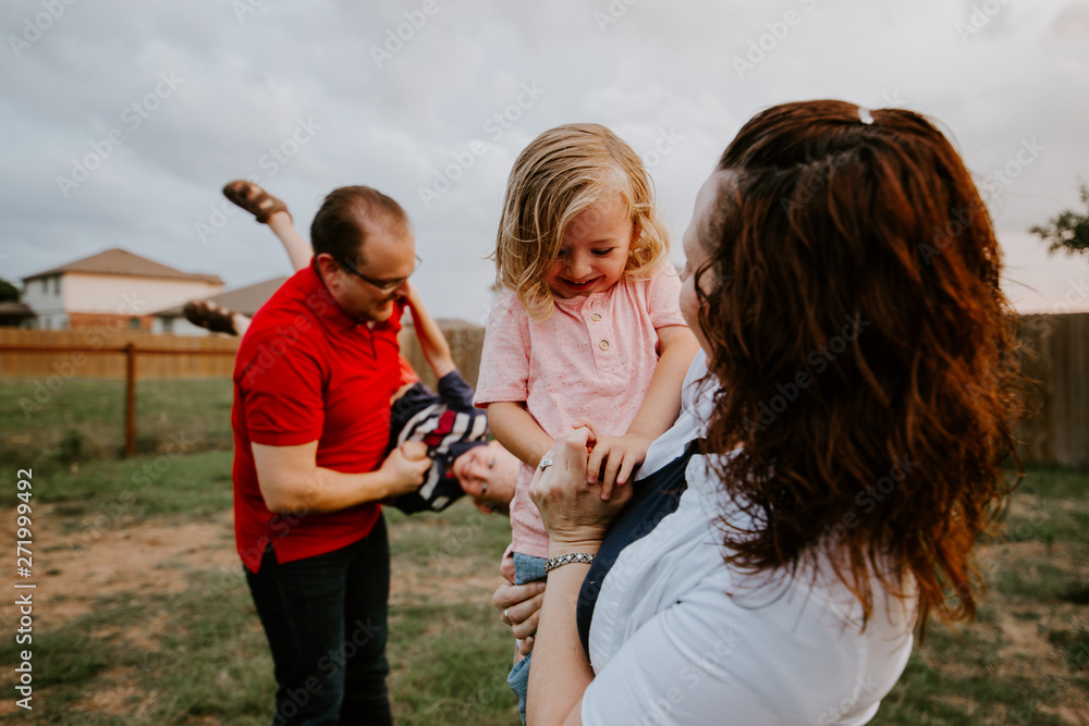 Happy family playing with sparkler fireworks together Happy family playing with sparkler fireworks together
