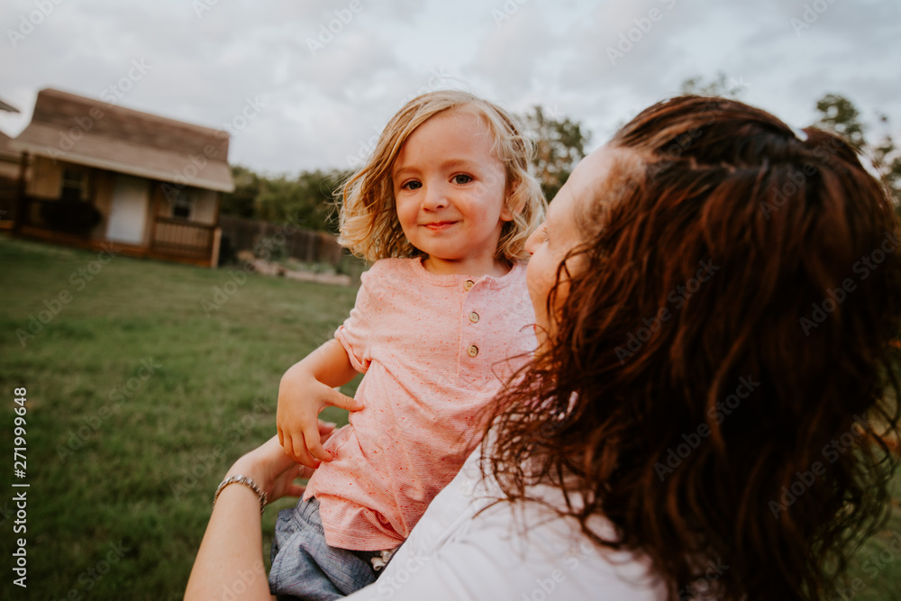 Happy mother playing with son