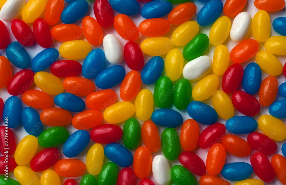 Brightly colored candy beans. Colourful jelly bean background. Jelly beans isolated on white background. Brightly colored candy beans. Colourful jelly bean background. Jelly beans isolated on white background.
