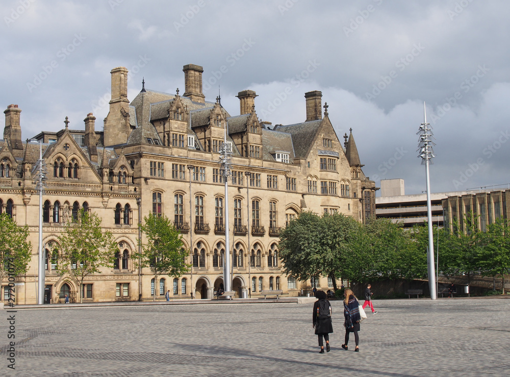 centenary square in bradford west yorkshire with people walking past the city hall and magistrates court buildings