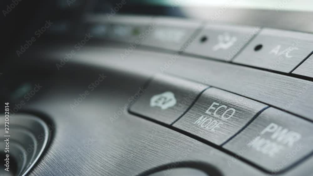 A person pushing the ECO mode button in a hybrid car in 4K. A person pushing the ECO mode button in a hybrid car in 4K.