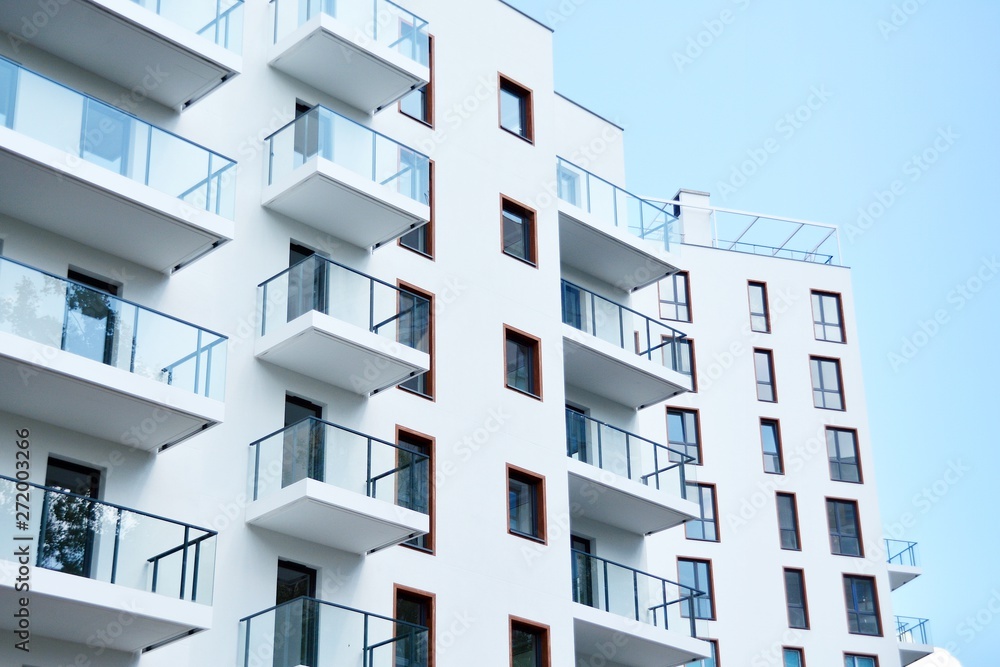 Modern apartment buildings on a sunny day with a blue sky. Facade of a modern apartment building Modern apartment buildings on a sunny day with a blue sky. Facade of a modern apartment building