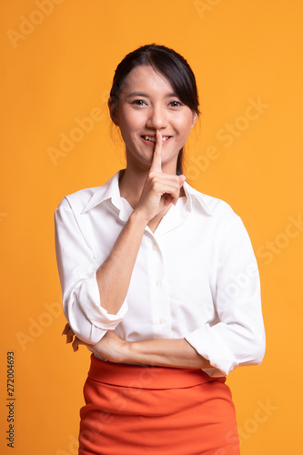 Asian girl smile show quite hand sign.