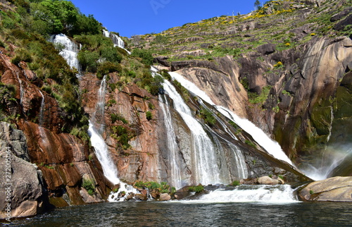 Colorful waterfall with rocks and vegetation. Ezaro  Spain.