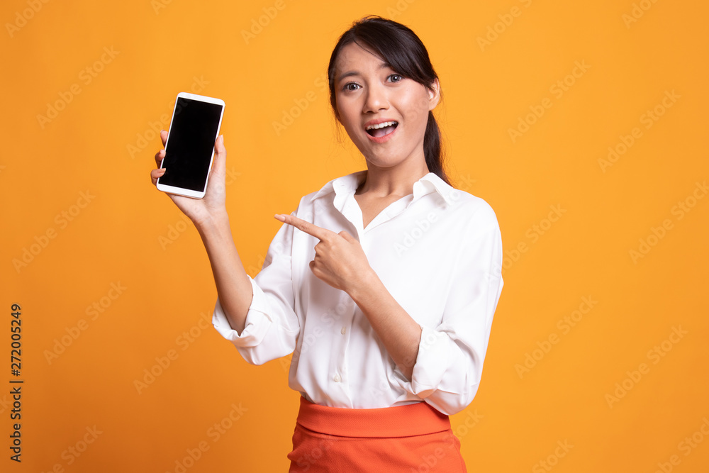 Excited Young Asian woman point to mobile phone. Excited Young Asian woman point to mobile phone.