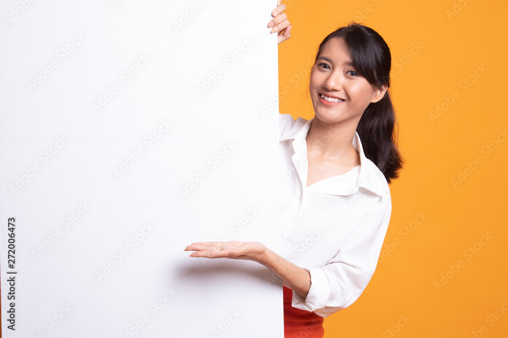 Young Asian woman present blank sign with palm hand. Young Asian woman present blank sign with palm hand.