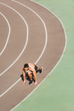 overhead view mixed race sportsman preparing to run at stadium