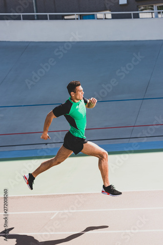 full length view of mixed race sportsman running at stadium