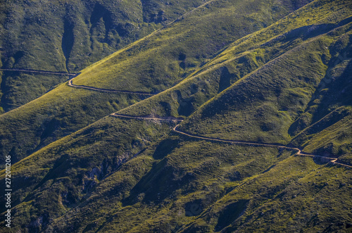 road in mountains and green trees 