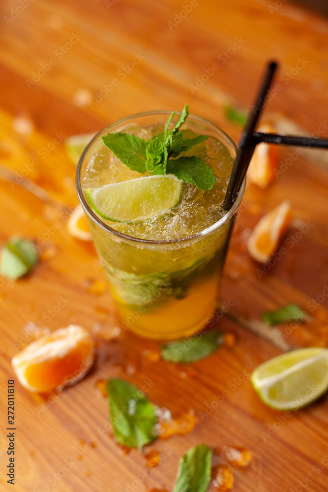 Refreshing seasonal citrus lemonade with ice, lime, orange, juice and sparkling water on a bar counter Refreshing seasonal citrus lemonade with ice, lime, orange, juice and sparkling water on a bar counter