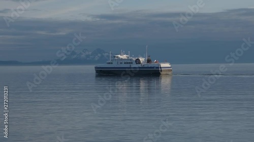 Ferry on the fjord with snow mountains photo