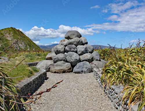 The pile of grey boulders near Tarakena Bay, North Island, New Zealand was built as a reminder of the point thar raw sewage used to be pumped into the Cook Straits. It is now nicknamed The Doo Doos. photo