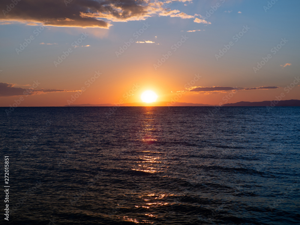 Beautiful orange sunset over dark blue sea