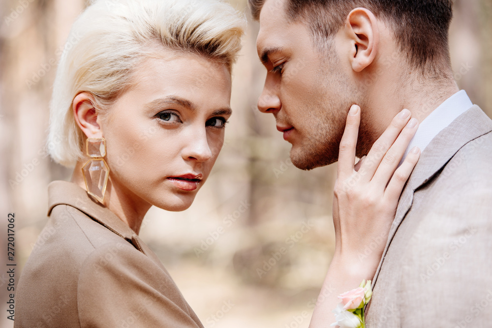 Naklejka premium Close up view of attractive woman touching man