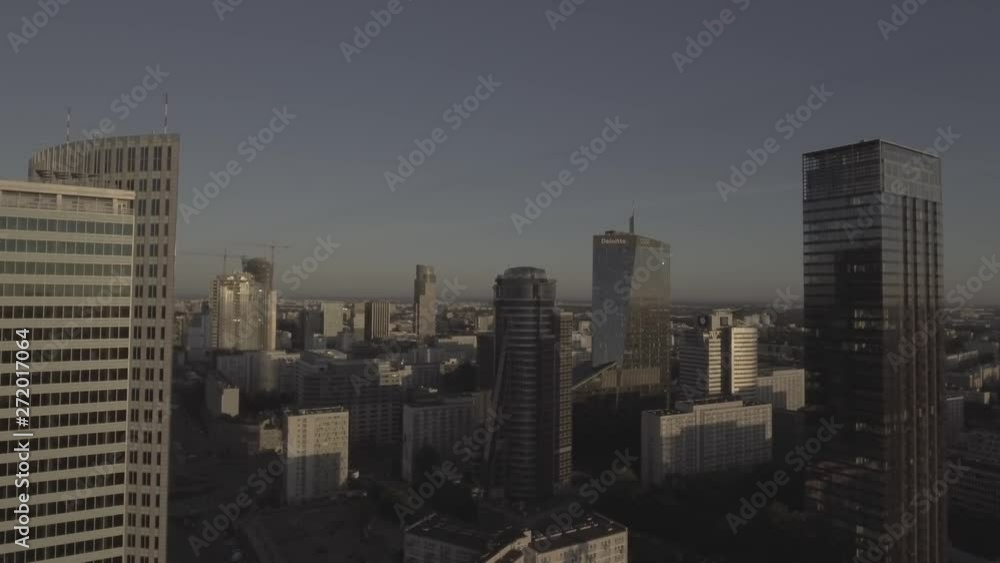 Aerial view tall skyscrapers in the center of Warsaw at sunrise. Financial office, business district. Reflection of the sun in glass skyscrapers. Shot on 4k, drone shot RAW. Aerial view tall skyscrapers in the center of Warsaw at sunrise. Financial office, business district. Reflection of the sun in glass skyscrapers. Shot on 4k, drone shot RAW.