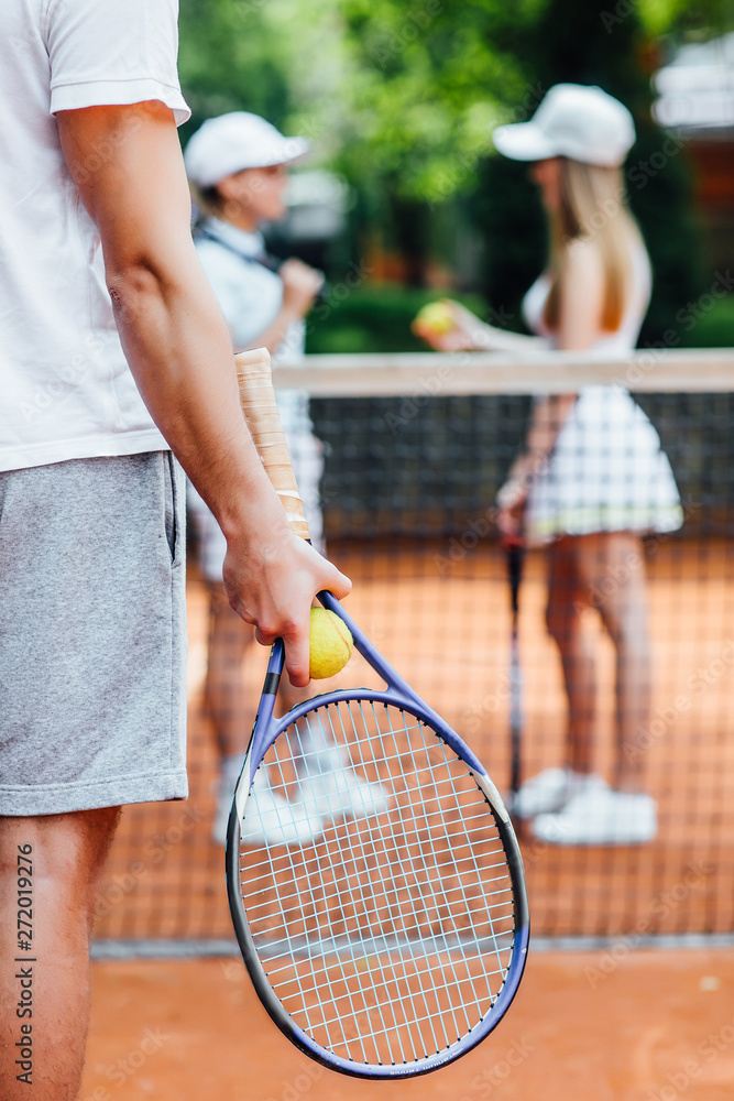 A tennis player  man prepares to serve a tennis ball during a match..