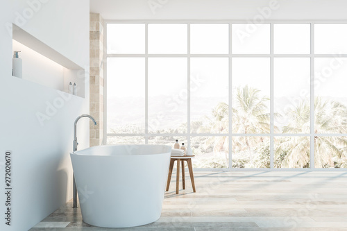 Side view of white and stone bathroom with tub