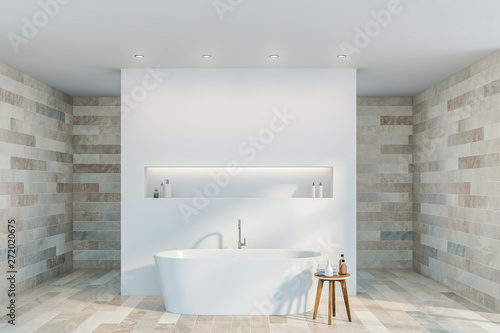 White and stone bathroom interior with tub