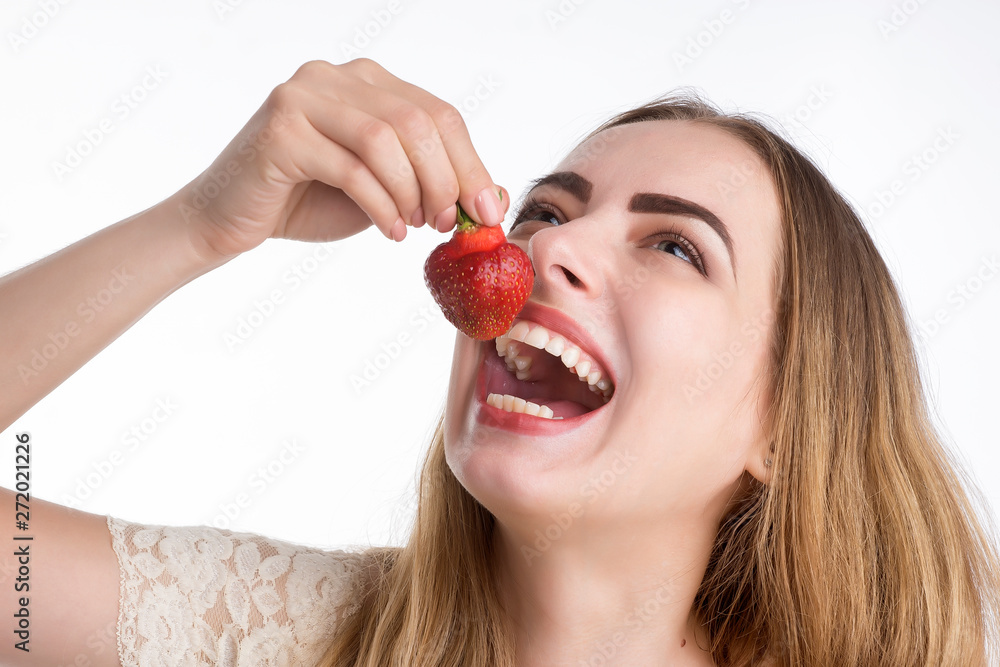 girl eagerly eating strawberries on white background. girl eagerly eating strawberries on white background.