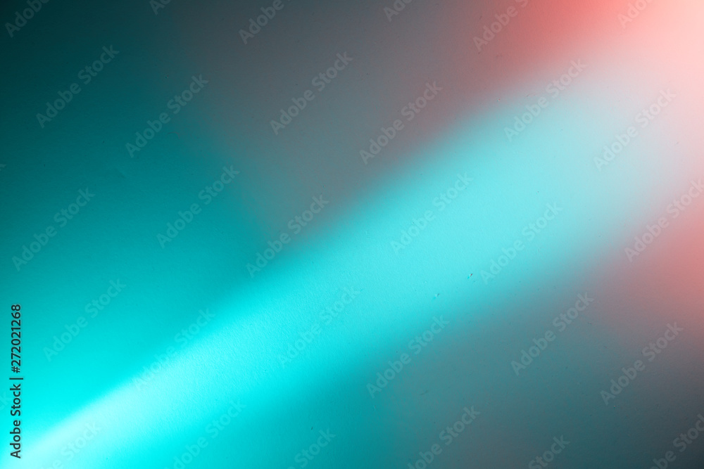 A light turquoise diagonal beam of light separates the turquoise and pink background