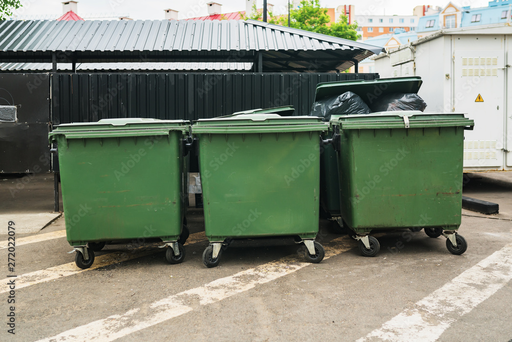Green garbage containers in the city street Green garbage containers in the city street