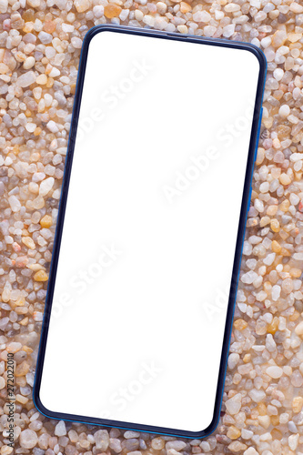 phone with a white screen on clean coarse sea sand