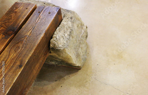 Massive wooden bench on a granite floor