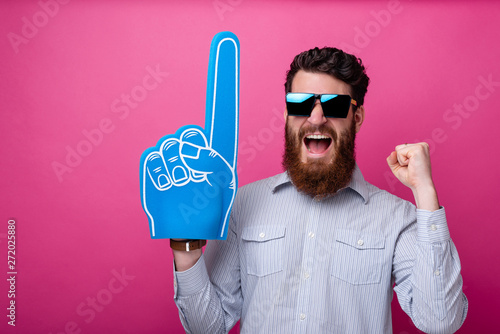 Bearded guy with big blue fan glove, screaming and support his team