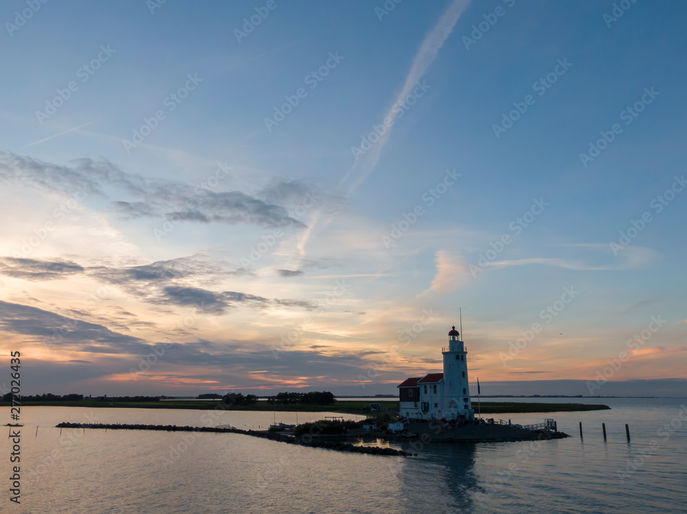 Aerial of lighthouse on peninsula in the Netherlands at sunset