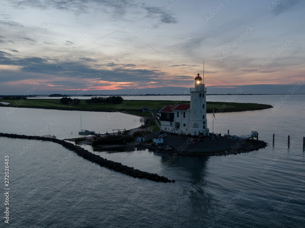 Aerial of lighthouse on peninsula in the Netherlands at sunset