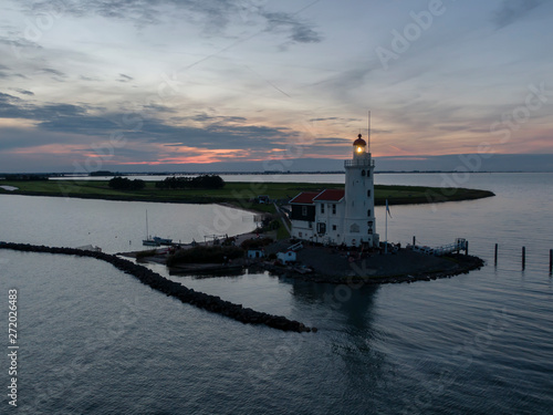 Aerial of lighthouse on peninsula in the Netherlands at sunset