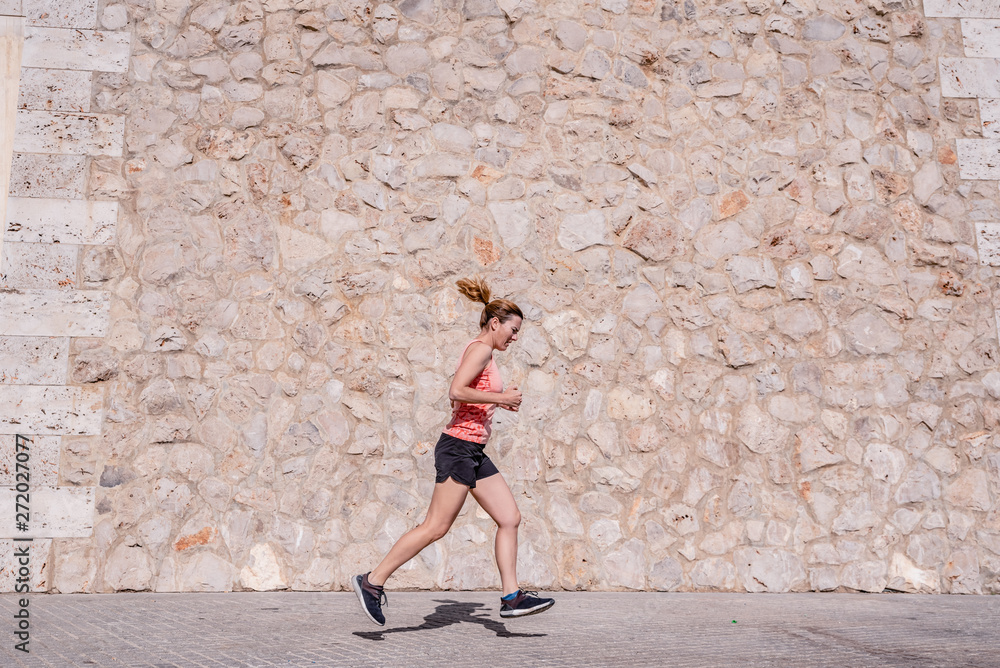 Φωτογραφία Middle aged woman athlete with fitness clothes doing exercises and running in the sun and sweating in summer