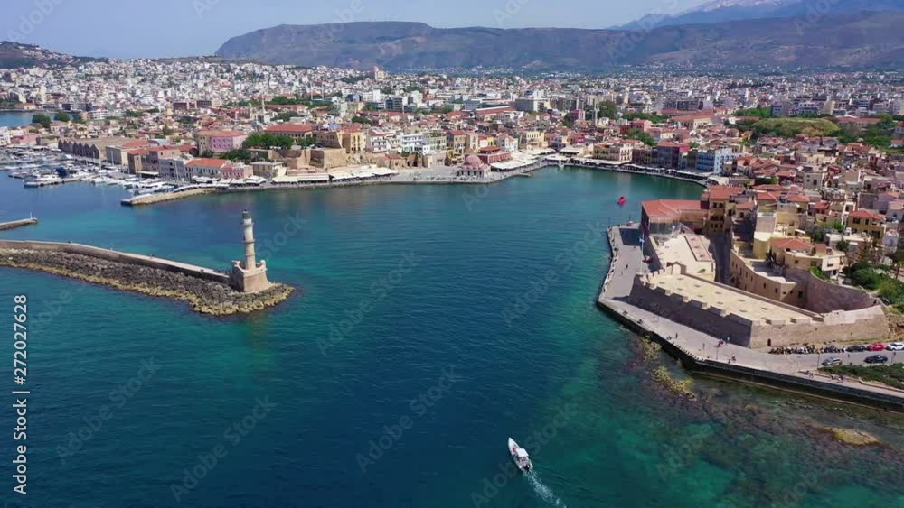 Aerial drone panoramic view video of iconic and picturesque Venetian old port of Chania with famous landmark lighthouse and traditional character, Crete island, Greece Aerial drone panoramic view video of iconic and picturesque Venetian old port of Chania with famous landmark lighthouse and traditional character, Crete island, Greece