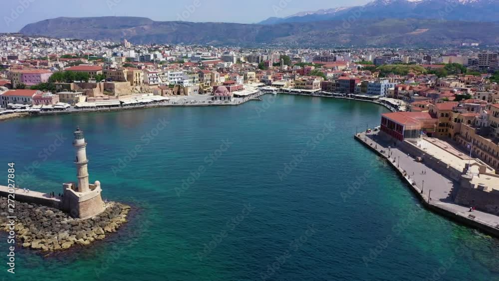 Aerial drone panoramic view video of iconic and picturesque Venetian old port of Chania with famous landmark lighthouse and traditional character, Crete island, Greece Aerial drone panoramic view video of iconic and picturesque Venetian old port of Chania with famous landmark lighthouse and traditional character, Crete island, Greece