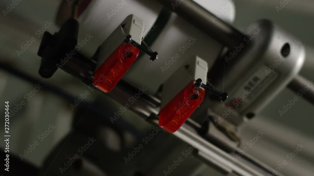 Thread break alarm indicator on an automated cotton textile winding machine in a factory in China Thread break alarm indicator on an automated cotton textile winding machine in a factory in China