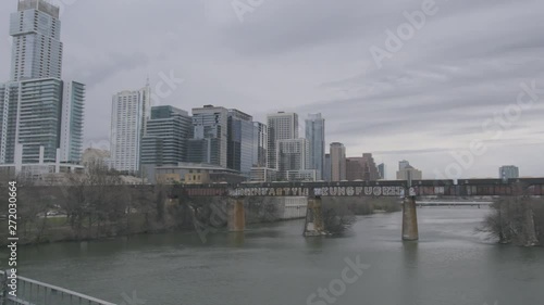 a freight train crosses the Colorardo River and heads into downtown Austin photo