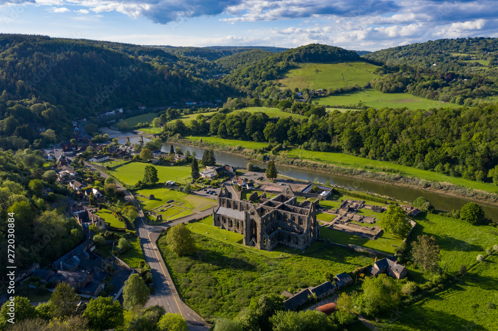 Aerial panoramic view of the ruins of Tintern Abbey, a Cistercian monastry located by the river Wye in South Wales, UK