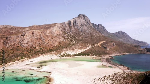 Aerial Dolly Shot of Balos Beach Moving Across the Lagoon towards the Mountains on Beautiful Sunny Day photo