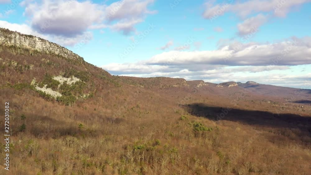 Drone soars by cliffs in the Catskill Mountains with dramatic cloud shadows on the forest below. in 4K. Drone soars by cliffs in the Catskill Mountains with dramatic cloud shadows on the forest below. in 4K.