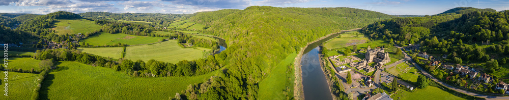 Aerial panoramic view of the ruins of Tintern Abbey, a Cistercian monastry located by the river Wye in South Wales, UK Aerial panoramic view of the ruins of Tintern Abbey, a Cistercian monastry located by the river Wye in South Wales, UK