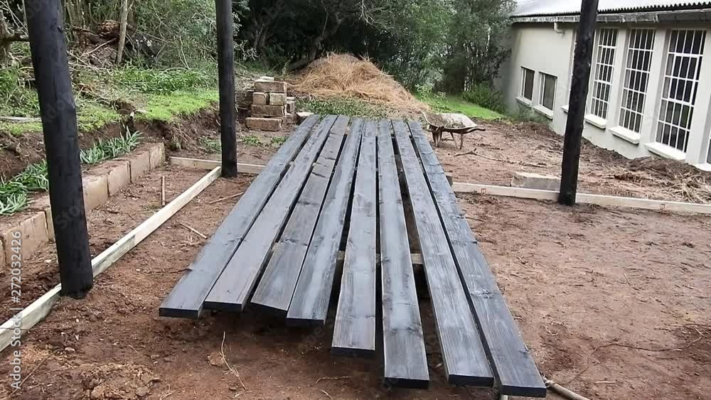 A Row of Freshly Painted Black Wooden Planks A Row of Freshly Painted Black Wooden Planks