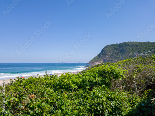 Itacoatiara beach and its restinga, preserved, with lots of green, blue waters, surf waves, clear sands, in Niteroi, RJ, Brazil. photo
